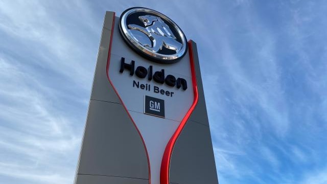 Large sign with the Holden and GM logos advertising the Neil Beer car dealership.