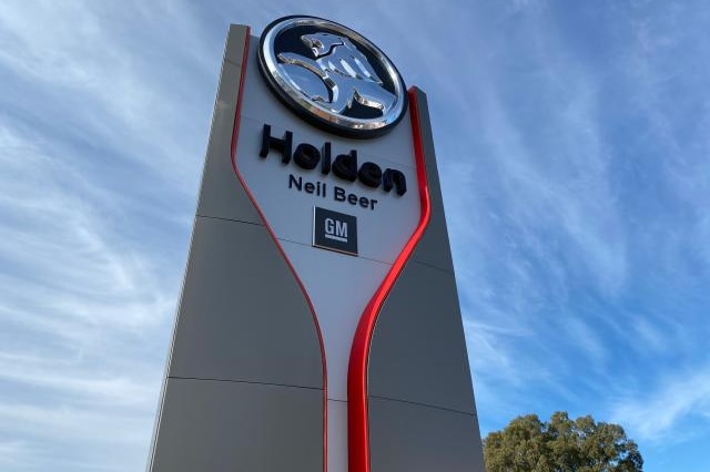 Large sign with the Holden and GM logos advertising the Neil Beer car dealership.