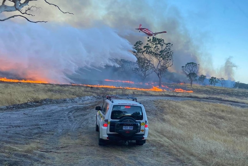 a four wheel drive car driving towards a bushfire 