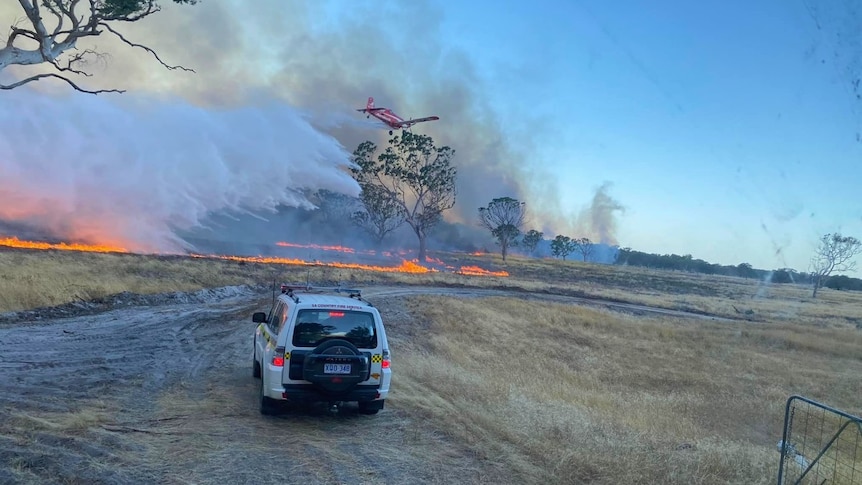 a four wheel drive car driving towards a bushfire 