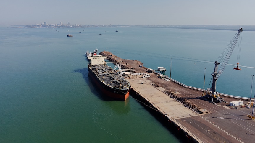 An aerial view of a ship anchored at a wharf part of the Darwin Port. 