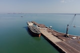 An aerial view of a ship anchored at a wharf part of the Darwin Port. 