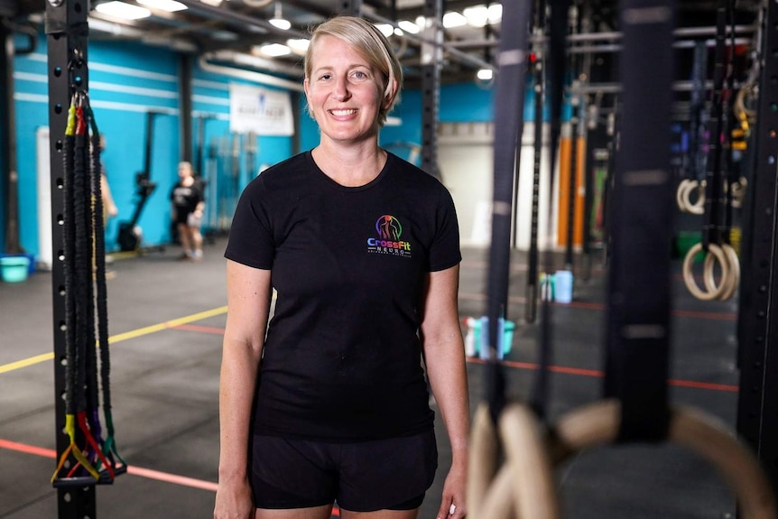 A woman, Jo Johnson, owner and manager of Brisbane gym CrossFit Neuro, smiling at her gym