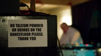 A sign reads 'no talcum powder on the dance floor'.