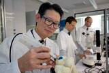 Professor Peter Choong of St Vincent's Hospital demonstrates a 3D printer filled with stem cell ink to treat knee injuries.
