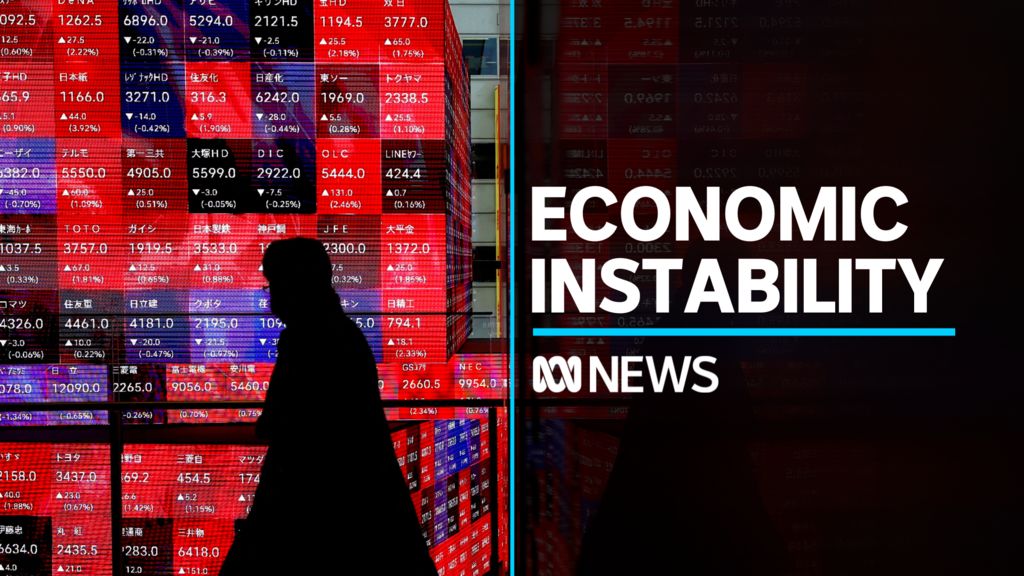 Economic Instability: Silhoueted person walks in front of stock board