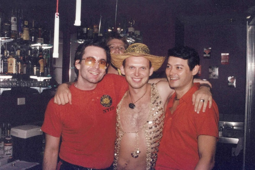 A vintage photo of Throb co-founders Tim Palmer and Mark Marcelis with a man in a gold sequined hat and vest.