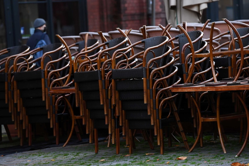 Stacked chairs are pictured on the first day of the temporary closing of restaurants.