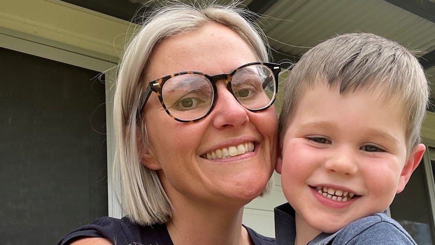 A woman with two smiling children