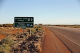 Yalgoo, Geraldton, Paynes Find towns road sign on an empty highway.