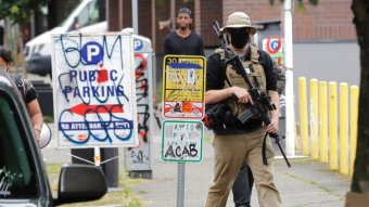 A man stands with a gun.