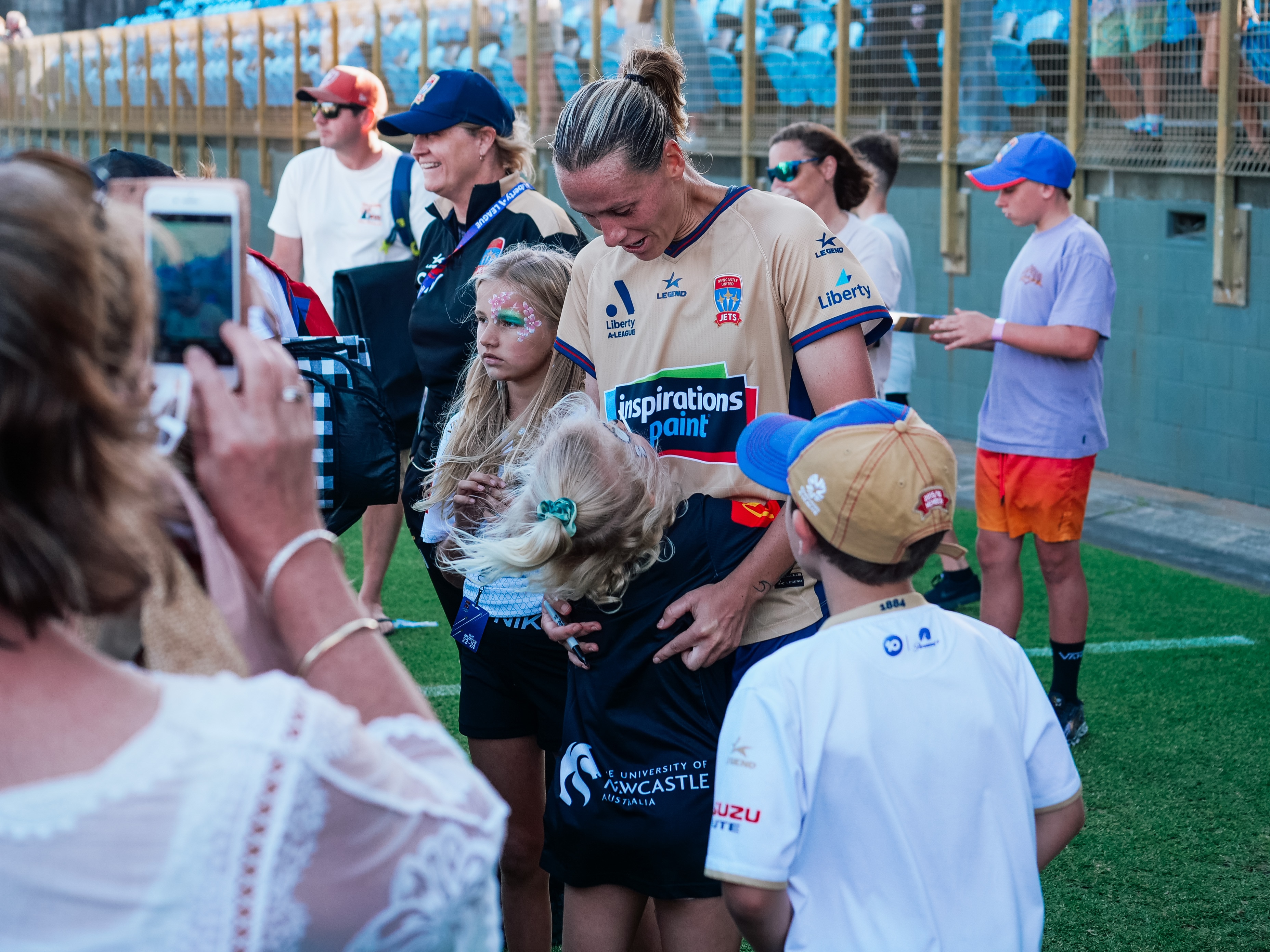 a soccer player hugs a fan