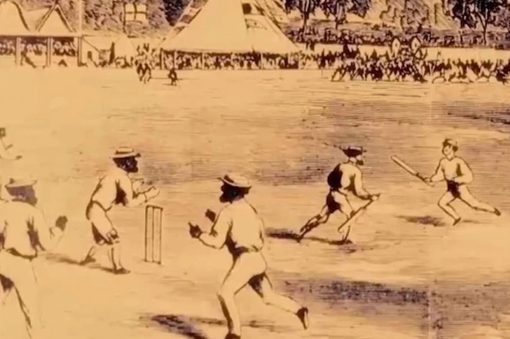 Фотография, на которой игроки из числа коренных народов в шляпах играют в крикет на животноводческих фермах.