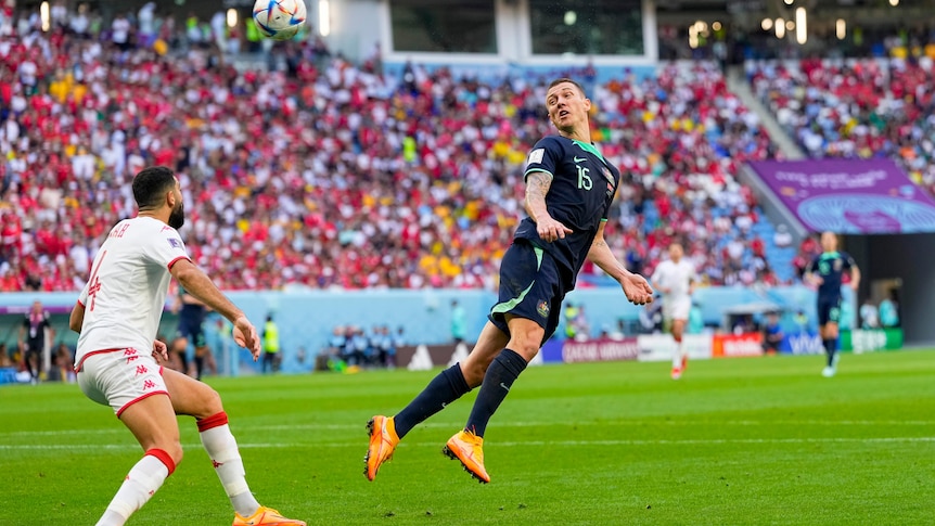 Mitch Duke flicks his head back and looks back towards the ball