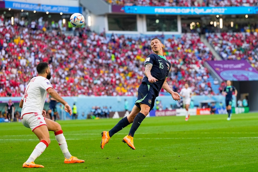 Mitch Duke flicks his head back and looks back towards the ball