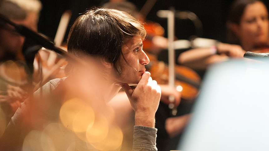 Jonny Greenwood looks on as the London Chamber Orchestra rehearses his music.