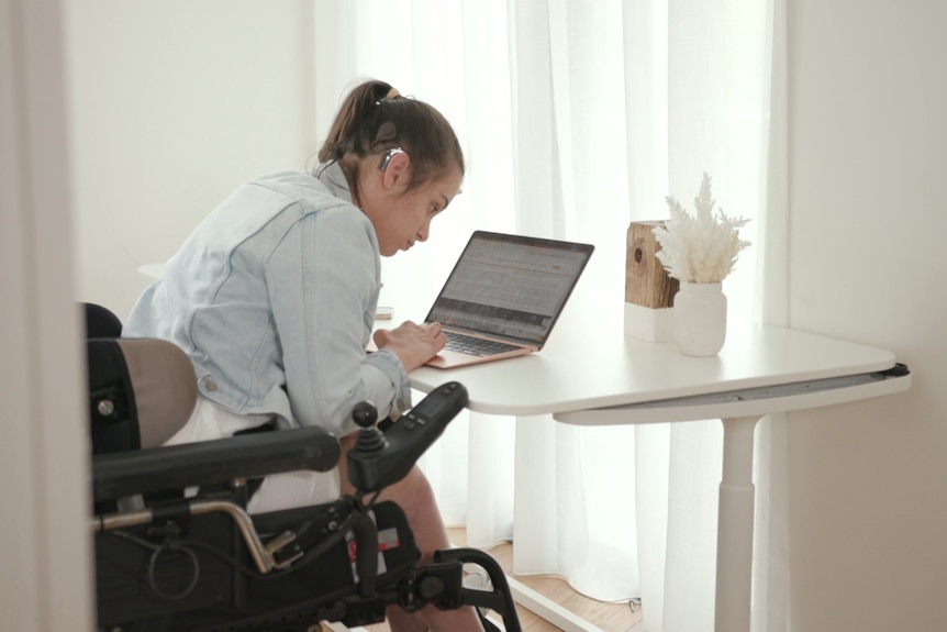 Sophie working on her laptop