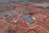 An aerial view of remote workers' accommodation at an outback mine with red dirt for landscape.  