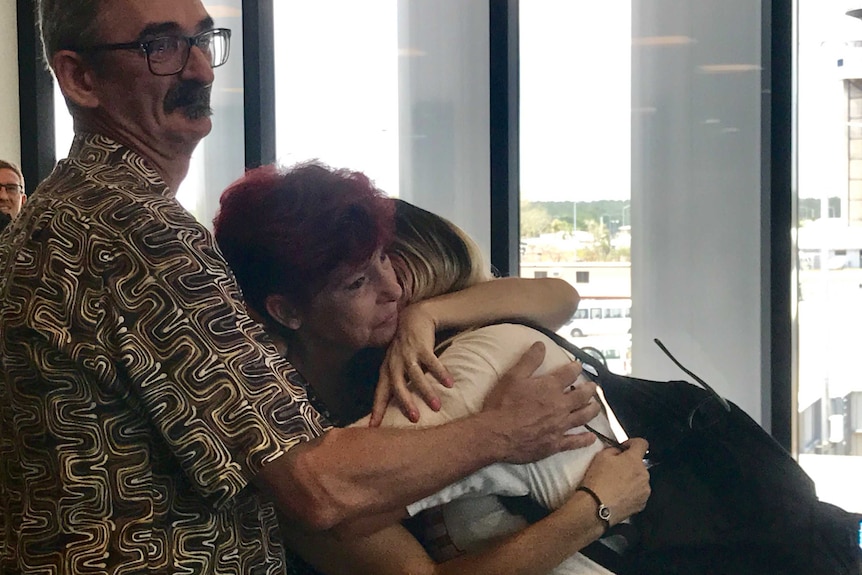 Beat Strub and Doris Kamber embrace their daughter Sharon at Darwin Airport