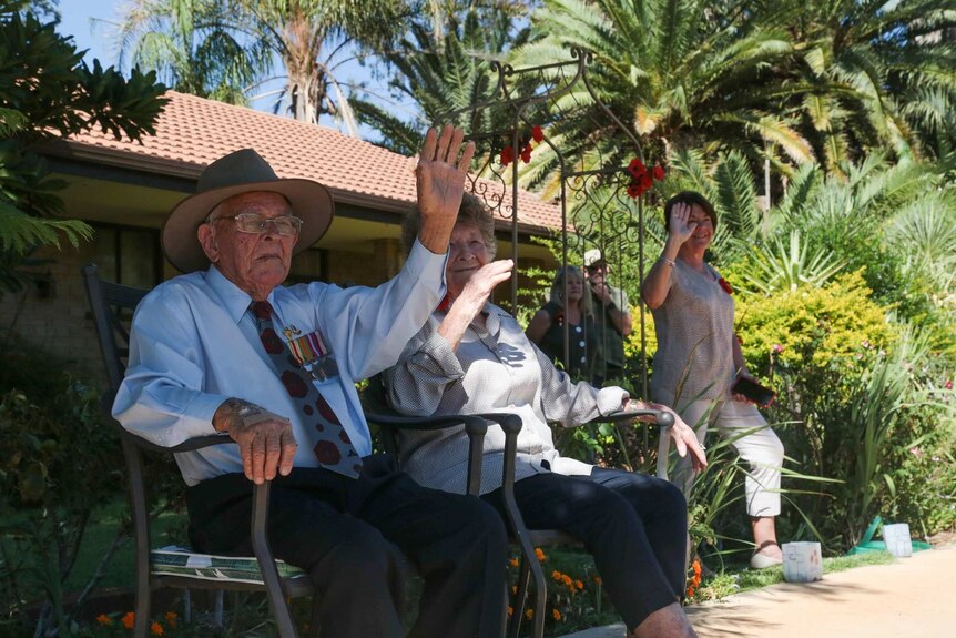Sydney Kinsman waves to residents in Alice Springs.