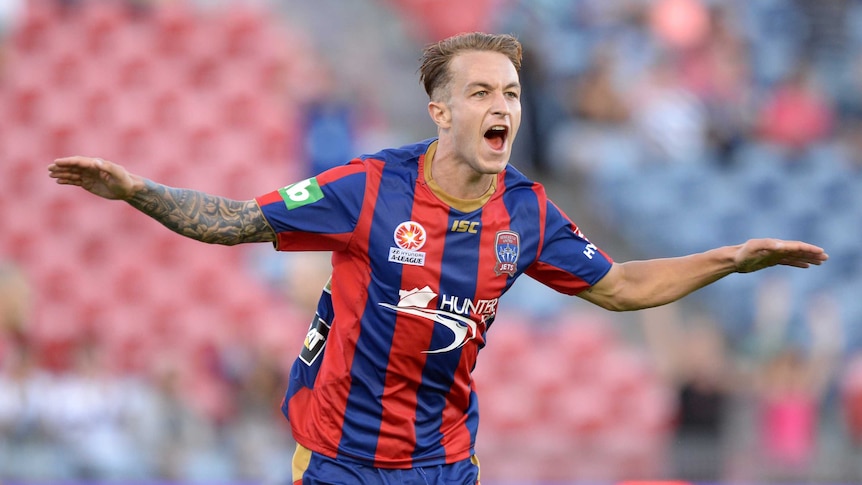 Adam Taggart celebrates a goal for Newcastle Jets