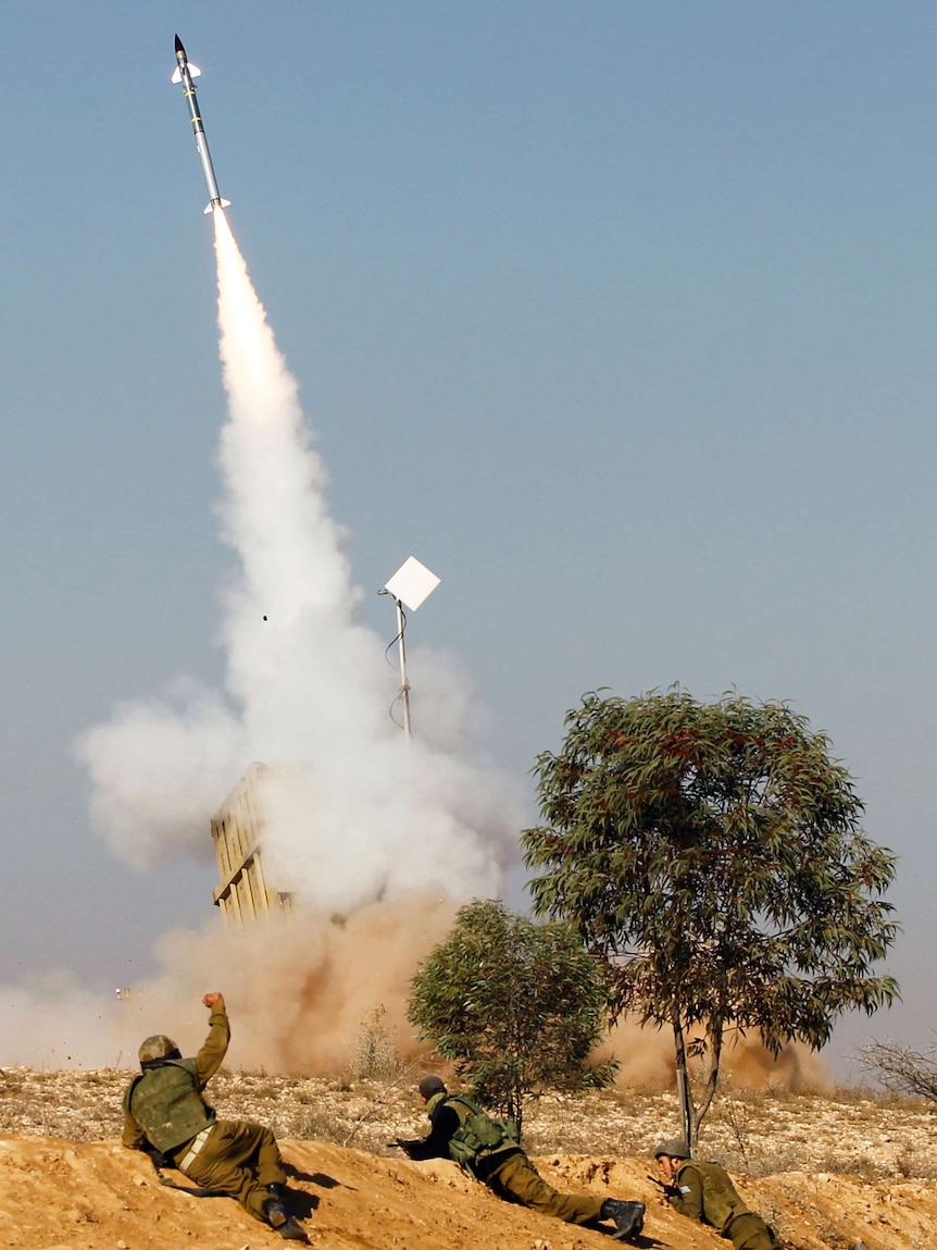 Israeli soldiers watch as an Iron Dome launcher fires an interceptor rocket near the southern city of Beersheba.