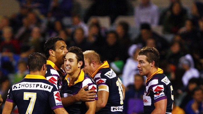 Billy Slater is congratulated by team-mates after scoring a try.