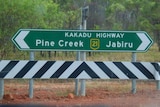 A photo of the Kakadu Highway sign pointing towards Pine Creek