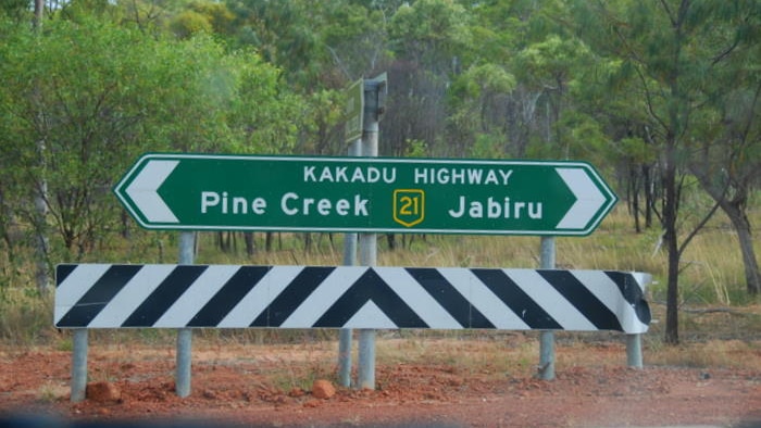 A photo of the Kakadu Highway sign pointing towards Pine Creek