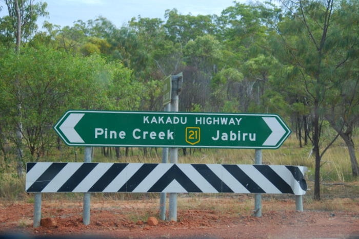 A photo of the Kakadu Highway sign pointing towards Pine Creek