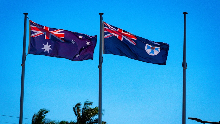 two flags and an empty flagpole