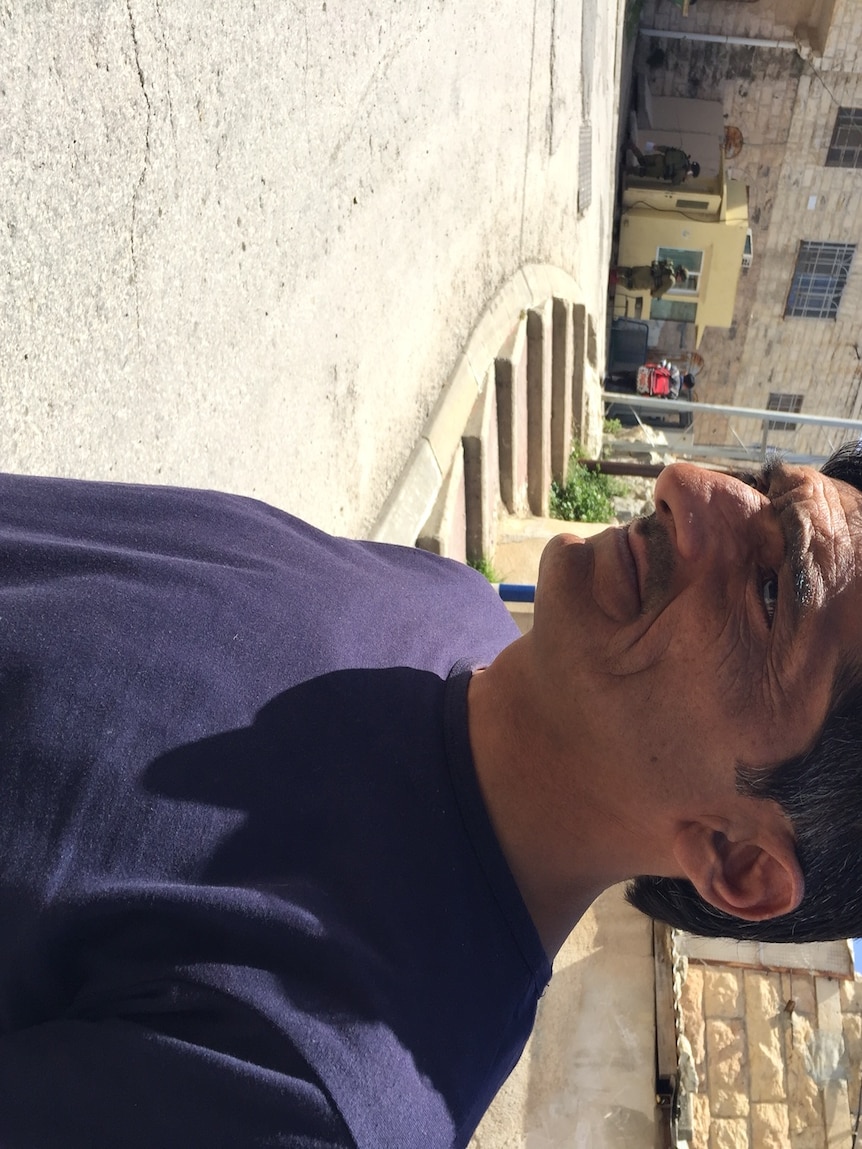 Emad Abu Shamsseyah at the spot where an Israeli soldier shot a subdued Palestinian attacker