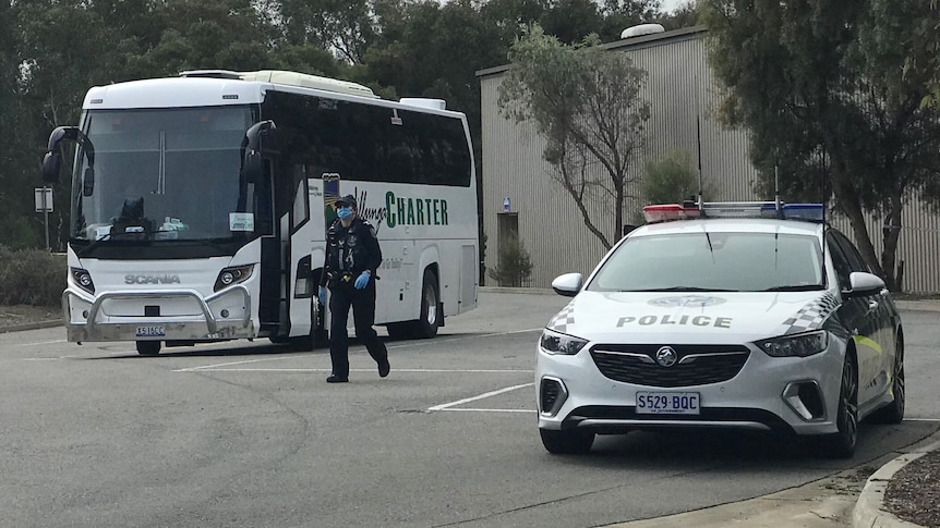 A police officer outside a bus.