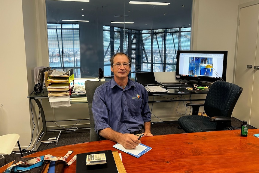 A man sits in an office