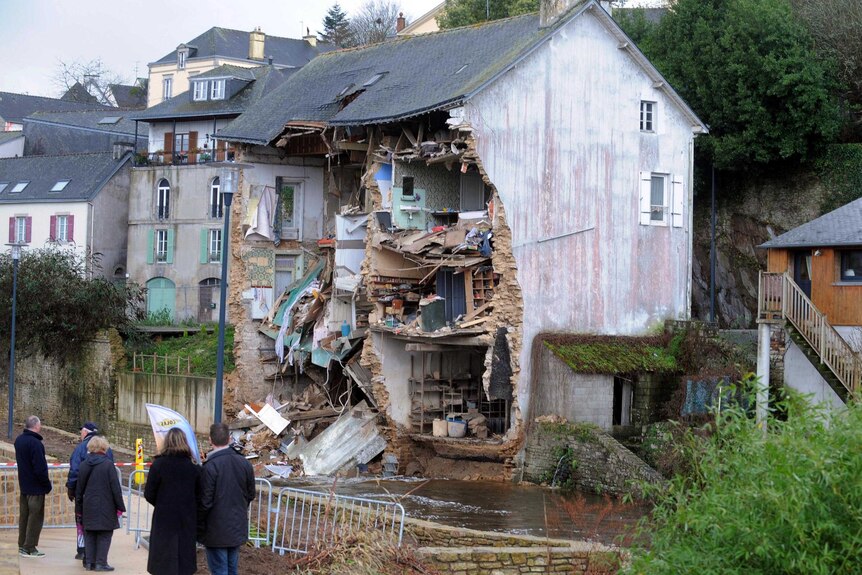 Facade of house in France collapses due to floods.