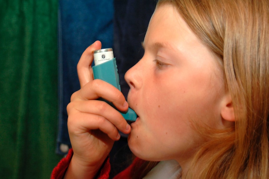 Child using asthma puffer