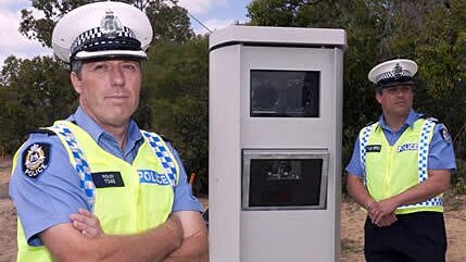 WA police officers stand next to fixed speed camera on the Mitchell Freeway on December 22, 2011.