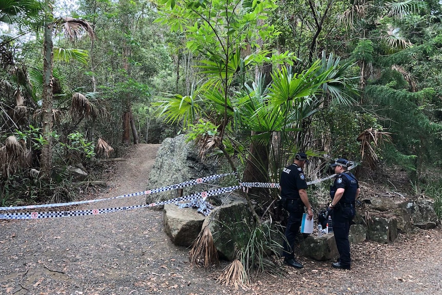 Police officers near a closed walking track on Mount Coot-tha, where human remains were found on November 8, 2017.