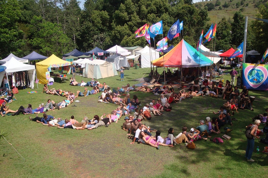 People lying on grass at Channon Craft Market.