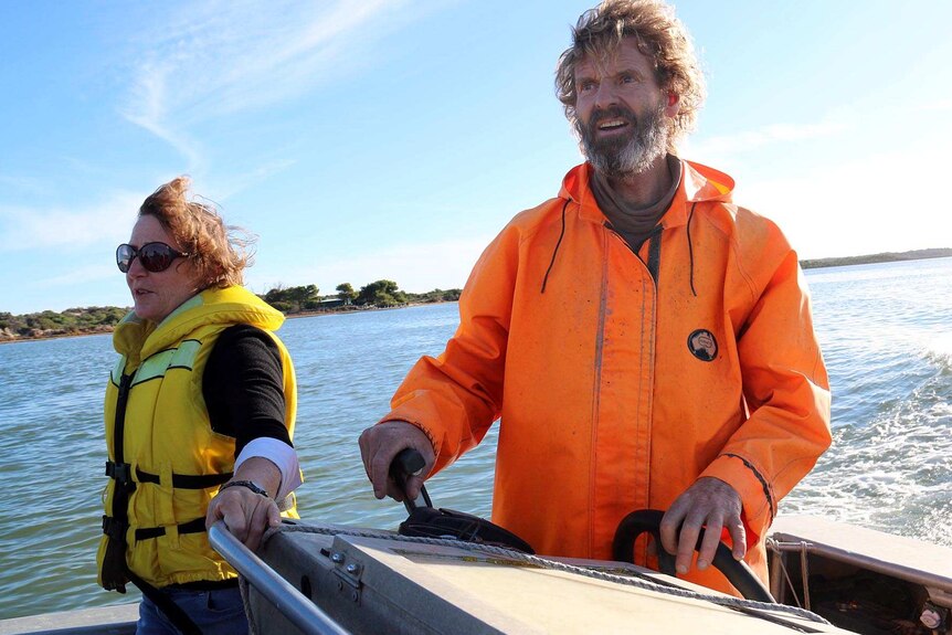 Isobel Redmond and Glen Hill on a boat in South Australia's Corrong.