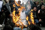 Indian activists in New Delhi burn an effigy