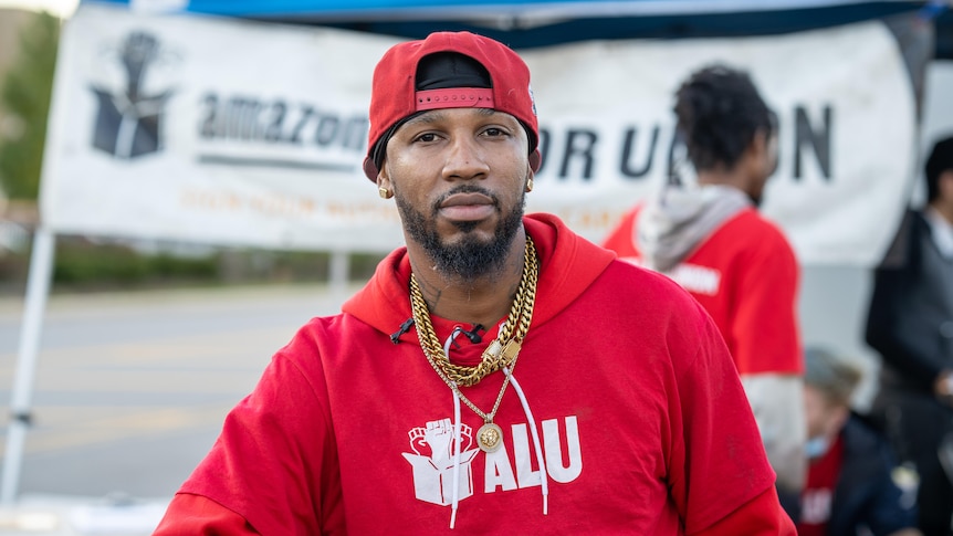 Christopher Smalls standing in front of the Amazon warehouse he hopes to unionise.