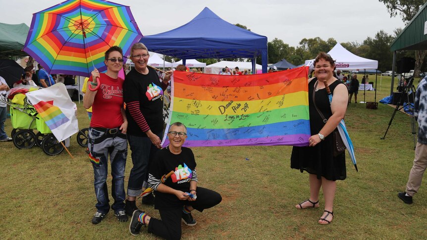 Revellers fly the rainbow flag at the pride march in Dubbo.