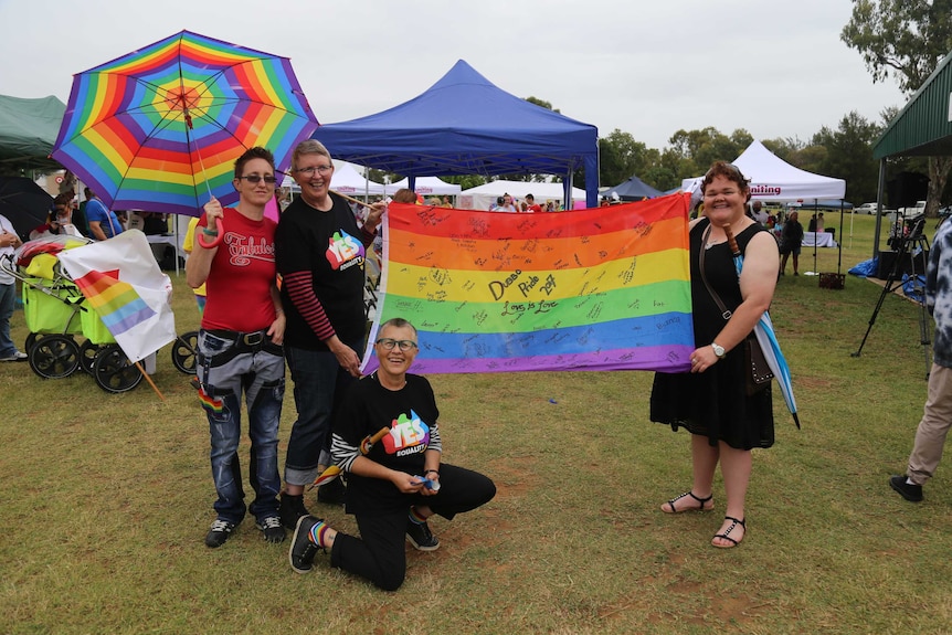 Revellers fly the rainbow flag at the pride march in Dubbo.