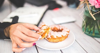 Hand holds Danish pastry.