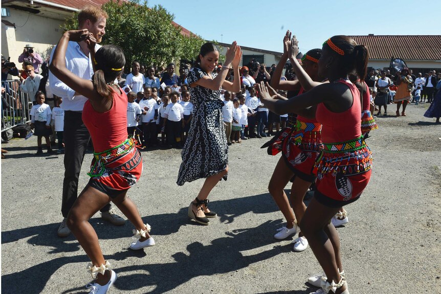 Prince Harry and Meghan move with female African dancers