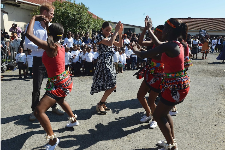 Prince Harry and Meghan move with female African dancers