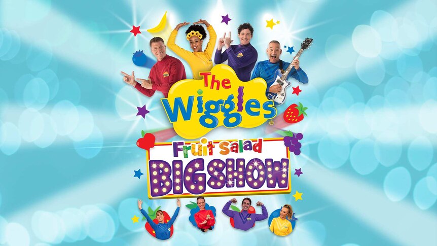 All eight Wiggles looking joyful, surrounded by animated stars and fruit around a big typeface for Fruit Salad Big Show
