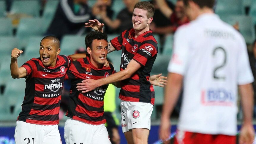 Mark Bridge is congratulated by his Wanderers team-mates after opening the scoring.