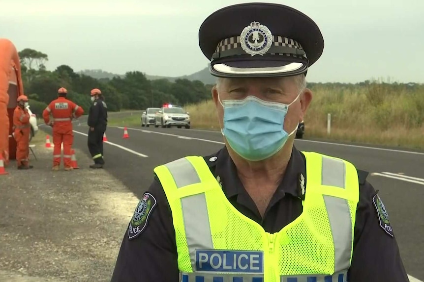 Superintendent Phil Hoff speaks to media on the side of a road